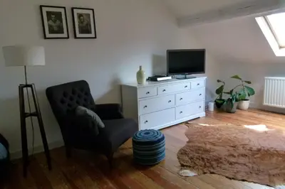 a living room with a chair and a television at Wetterdelle in Heers