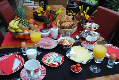 a table full of food and drinks and a table with food at B&B Elegance Hamont in Hamont-Achel