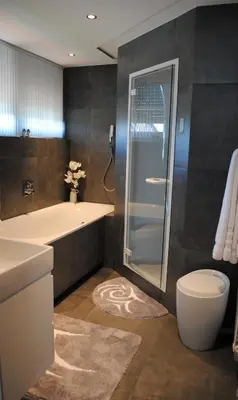 a bathroom with a shower and a sink and a toilet at B&B Elegance Hamont in Hamont-Achel