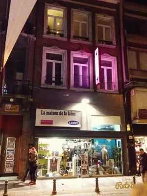 a store on a city street at night at Appartement Au Coeur de Liege in Liège