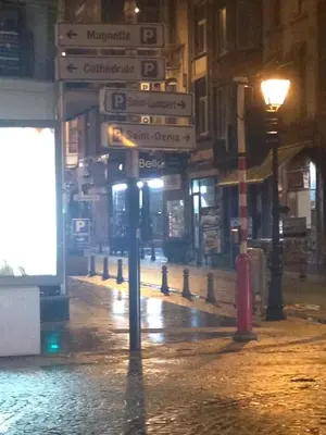 a street sign on a city street at night at Appartement Au Coeur de Liege in Liège