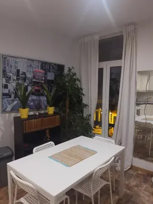 a white dining room with a white table and chairs at Appartement Au Coeur de Liege in Liège