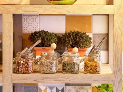 a shelf with jars of nuts and seeds on it at Park Inn By Radisson Hasselt in Hasselt