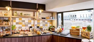 a kitchen with a counter with food on it at Park Inn By Radisson Hasselt in Hasselt
