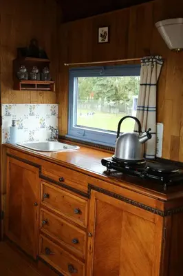 a kitchen with a sink and a tea kettle on a stove at B&B Dream On Wheels in Lommel