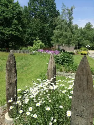 a garden with rocks in a field of flowers at Vakantieverblijf Volmolen B&B in Maaseik