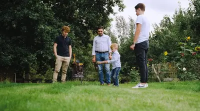 a group of people standing in the grass at De Pluktuin in Kortessem