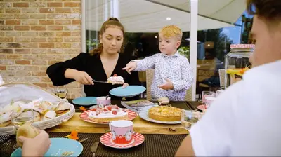 a woman and a child eating cake at a table at De Pluktuin in Kortessem