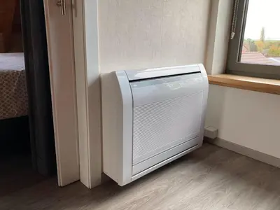 a heater in a room next to a window at Gastenverblijf Chambre dAmis in Heers