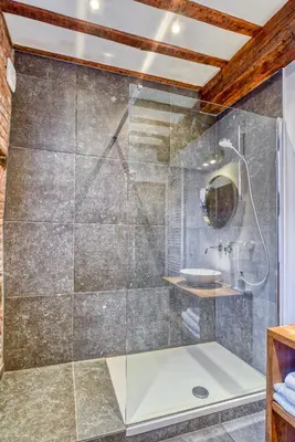 a shower with a glass door in a bathroom at Chez Mamy in Liège