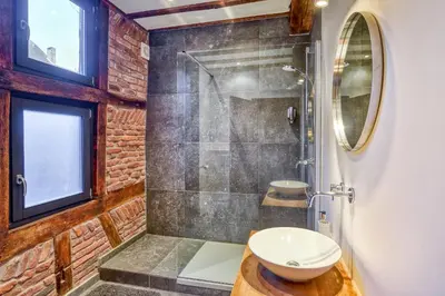 a bathroom with a shower with a toilet and a sink at Chez Mamy in Liège