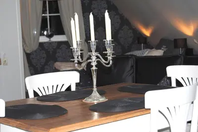 a dining room table with candles on top of it at 't Poorthof in Borgloon