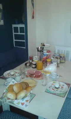 a table with bread and other food on it at Villa Lumina in Membach