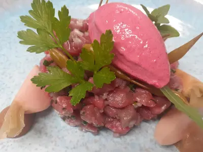 a plate of food with a pomegranate on top at La Ferme du Hélivy in Jalhay