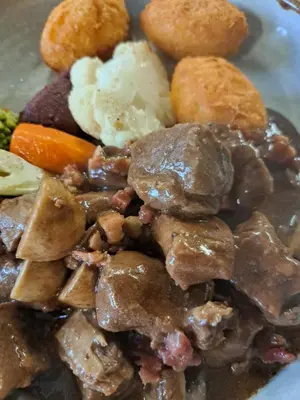 a plate of food with meat and vegetables at La Ferme du Hélivy in Jalhay
