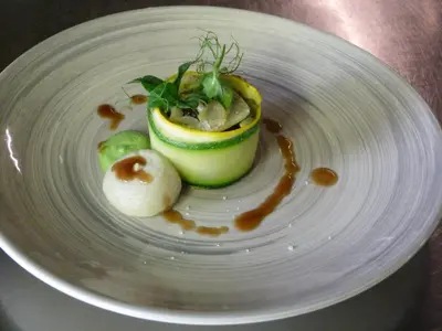 a plate of food with an avocado on it at La Ferme du Hélivy in Jalhay