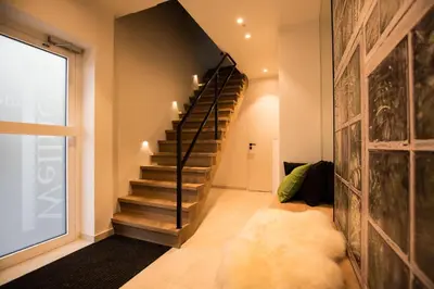 a hallway with a staircase in a house at Wellness Hasselt B&B in Hasselt