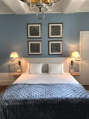 a bedroom with a bed with a blue wall at Faubourg Saint Martin in Liège
