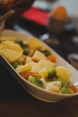 a bowl of food with vegetables on a table at B&B The Street Lodge in Liège