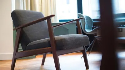 a chair sitting next to a desk in a room at B&B The Street Lodge in Liège