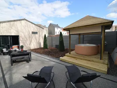 a gazebo with chairs and a table and a grill at Holiday Home in Welkenraedt with Sauna in Welkenraedt