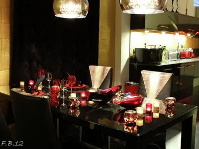a dining table with red glasses and candles on it at Holiday Home in Welkenraedt with Sauna in Welkenraedt