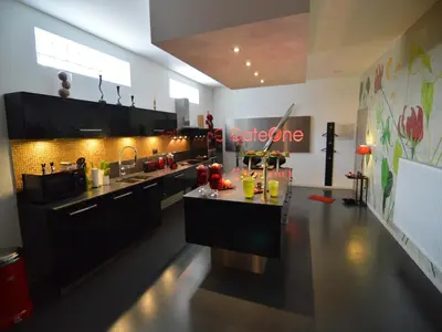 a kitchen with black cabinets and a counter top at Holiday Home in Welkenraedt with Sauna in Welkenraedt