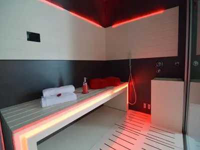 a bathroom with a bench with towels on it at Holiday Home in Welkenraedt with Sauna in Welkenraedt
