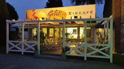a restaurant with tables and chairs in front of it at Ferienhaus Congolo in Lontzen