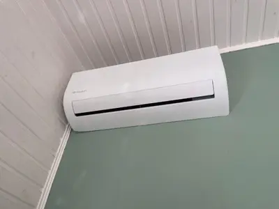 a white air conditioner hanging from a ceiling at Chalet Sint-Hubertus in Zutendaal