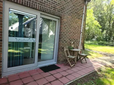 a patio with two chairs and a table next to a building at Den 1 Hengelhoef in Houthalen-Helchteren