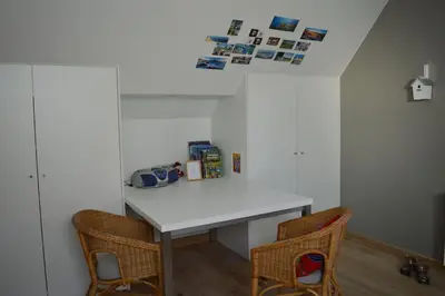 a room with a white table and two chairs at Maison Margriet in Tongeren