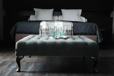 a bed with a table with glasses on it at B&B Villa des Roses in Hasselt