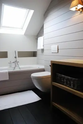 a bathroom with a toilet and a sink and a window at B&B Villa des Roses in Hasselt