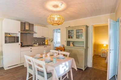 a kitchen and dining room with a table and chairs at Chalet Relax in Zutendaal