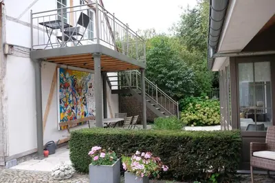 a balcony on the side of a house with flowers at Abeljano in Hasselt