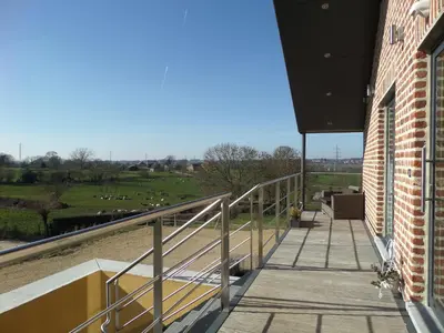 a balcony of a building with a view of a field at Les Coteaux du Vinave in Herve