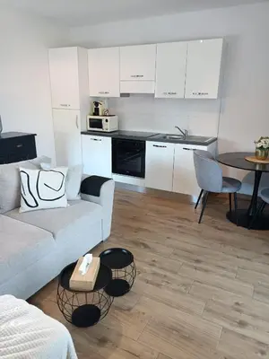 a living room with a couch and a table at InContri in Liège