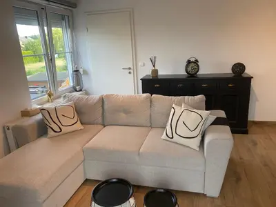 a living room with a couch with pillows on it at InContri in Liège