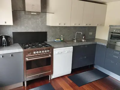 a kitchen with a stove and a sink at Cosy Corner in Lommel