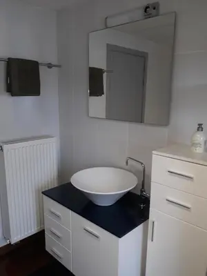 a bathroom with a white sink and a mirror at Cosy Corner in Lommel