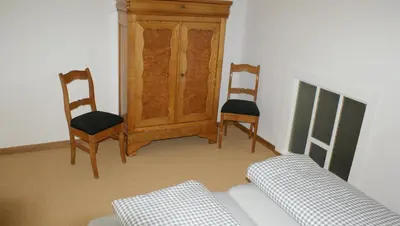 a living room with two chairs and a couch at Übernachten im ehemaligen Zollgebäude in Hauset