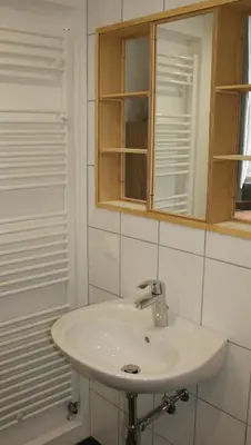 a bathroom with a white sink and a mirror at Übernachten im ehemaligen Zollgebäude in Hauset