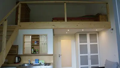 a loft bed in a kitchen with a sink at Übernachten im ehemaligen Zollgebäude in Hauset