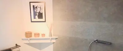 a bathroom with a shower and a picture of a dog at Lyves in Liège