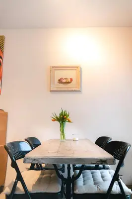 a table with chairs and a vase on top of it at Lyves in Liège