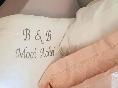 a bed with a pillow with the words bed moon addict at Bed and breakfast Mooi Achel in Achel