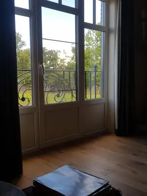 an empty room with an open door and a balcony at Bed and breakfast Mooi Achel in Achel