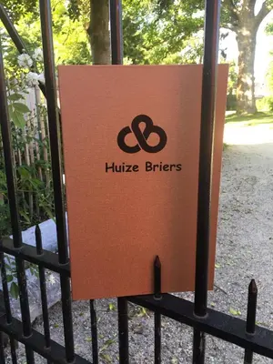 a sign on a gate in front of a fence at B&B Huize Briers in Bilzen