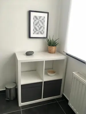 a white shelf in a room with a plant on it at L'Inizio Suite in Herve